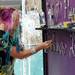 Artist Kiaralinda (no last name) of Florida, adjusts a "Believe" sign in her booth on E. Liberty St. during the State St. Art Fair on Wednesday, July 17, 2013. Melanie Maxwell | AnnArbor.com